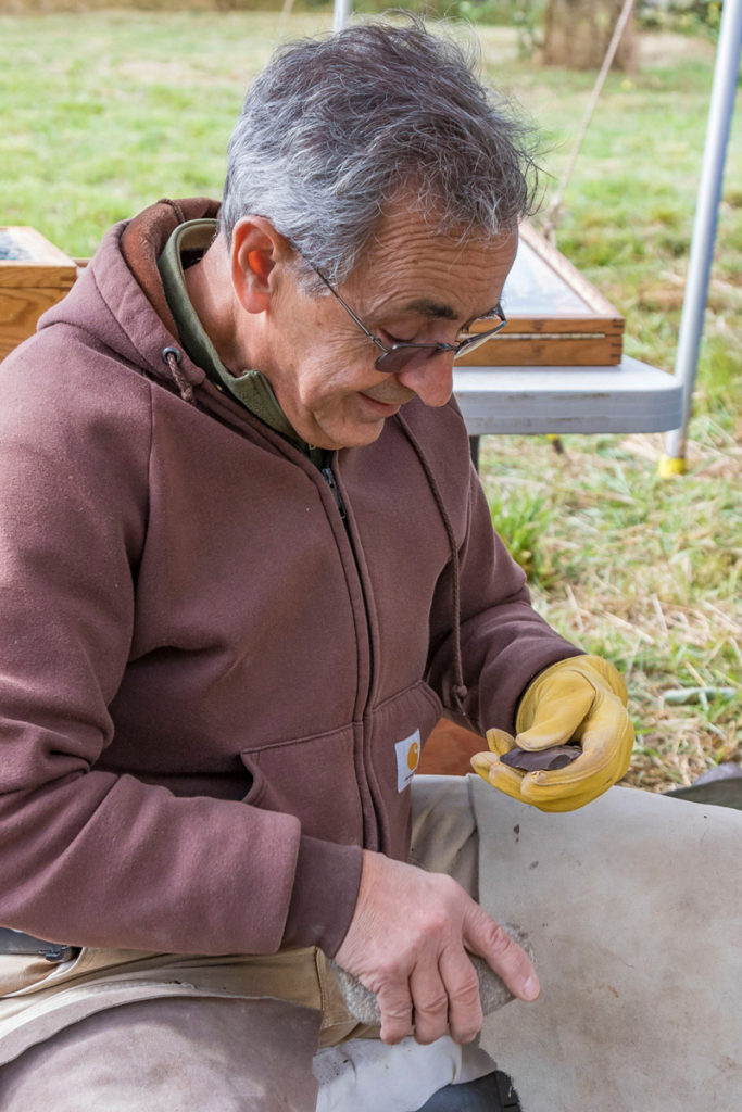 Dan Stueber, Portland demontrating the making of a Native American utilty tool made of pertrified wood. Photo by Mike Schultz.