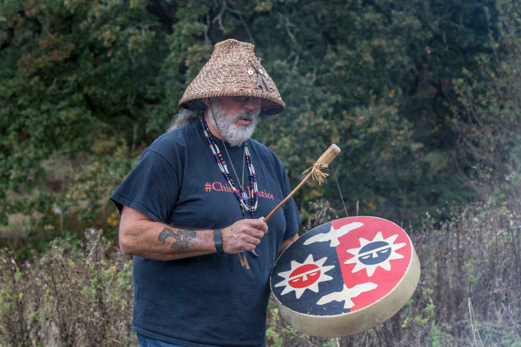 Chinook Tribal Vice Chairman, Sam Robinson playing a drum during the blessing of food and friendship before the traditional salmon bake at the Cathlapotle Plankhouse, Sun., Oct. 2 at the Carty Unit of the Ridgefield National Wildlife Refuge during Bird Fest. Photo by Mike Schultz.