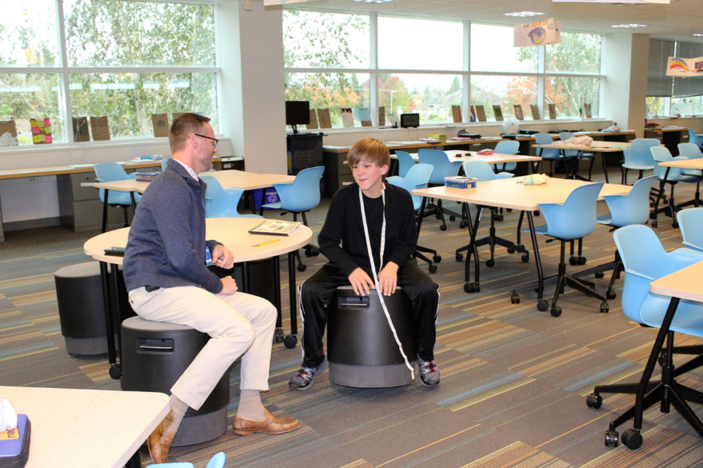 Aaron Smith, principal of the new Project Based Learning Middle School sits on 'buoy chairs'