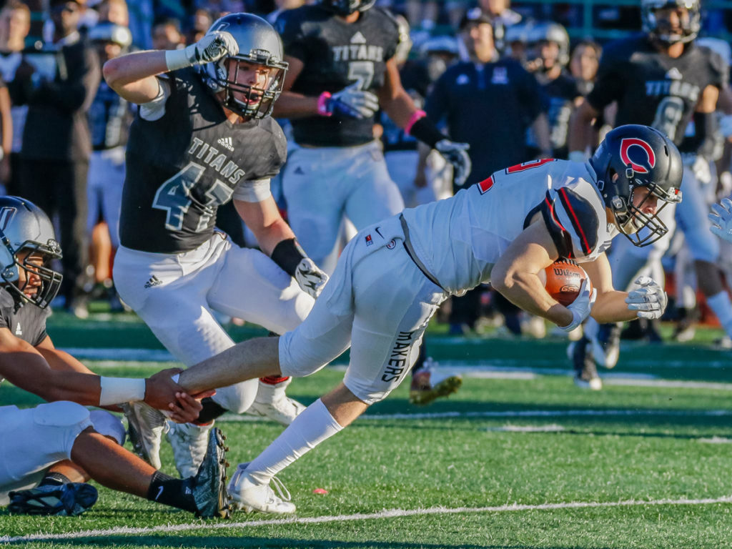 Camas wide receiver Ryan Rushell (2) gets caught by the foot by a Union defender.