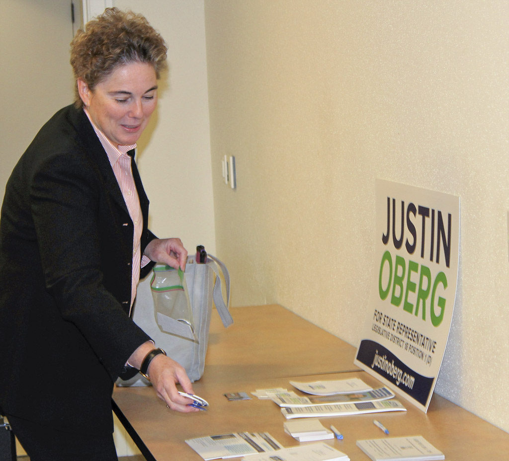 Vancouver Public Schools School Board Director Kathy Gillespie, places her information on a table at the Neighborhood Associations Council of Clark County’s candidates forum for Legislative District 18. Gillespie is running for a seat in the state House of Representatives against current Rep. Liz Pike. Photo by Kelly Moyer