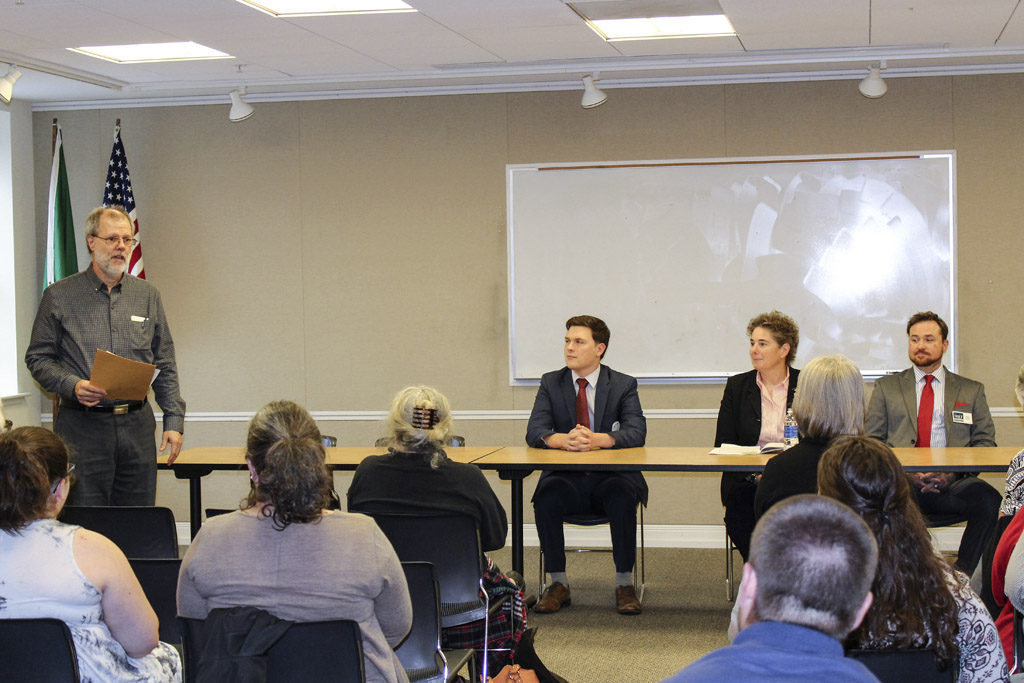 Neighborhood Associations Council of Clark County Chairman Paul Ballou (far left) prepares to moderate a bipartisan candidates forum at the Camas Library on Wed., Oct. 12, for six candidates running for state house and senate seats in Legislative District 18. Present at the event was Republican incumbent Rep. Liz Pike (not pictured) and three Democratic challengers Justin Oberg (left, at table), Kathy Gillespie (center, at table) and Eric Holt (right, at table). Photo by Kelly Moyer