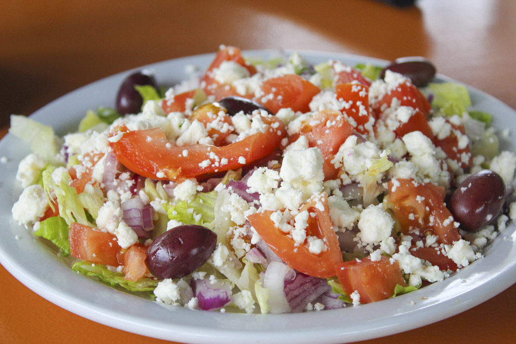 A couple of salads are available on the menu at George’s Molon Lave, including a traditional Greek salad made with olives, tomatoes, cucumbers, onions and feta cheese. Photo by Joanna Yorke