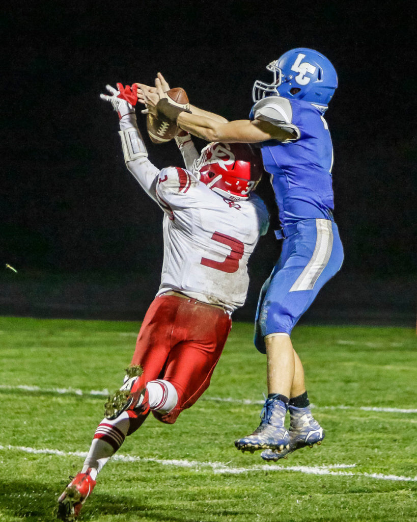 La Center fullback Isaac Johnson wrestles the ball away from Castle Rock defensive back Nate Myklebust (3) to score a touchdown. 