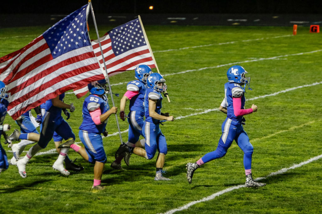 La Center football team charges onto the field before a win against Castle Rock Friday at La Center High School. 