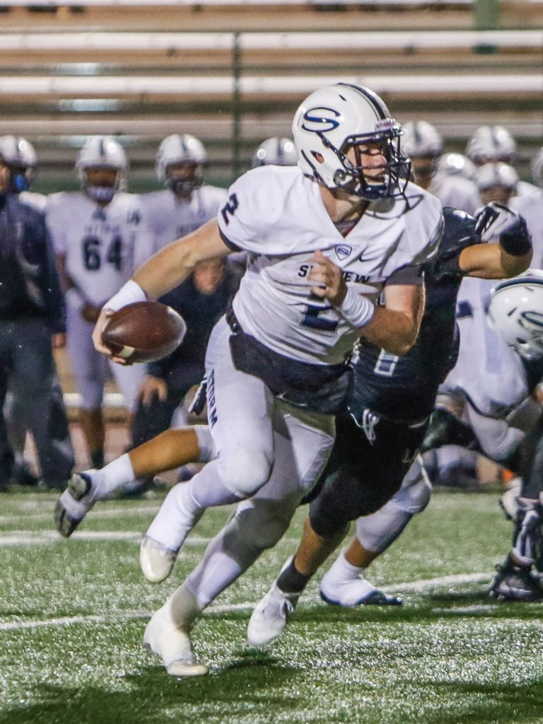 Skyview quarterback Brody Barnum (2) runs for yards against Union. Photo by Mike Schultz
