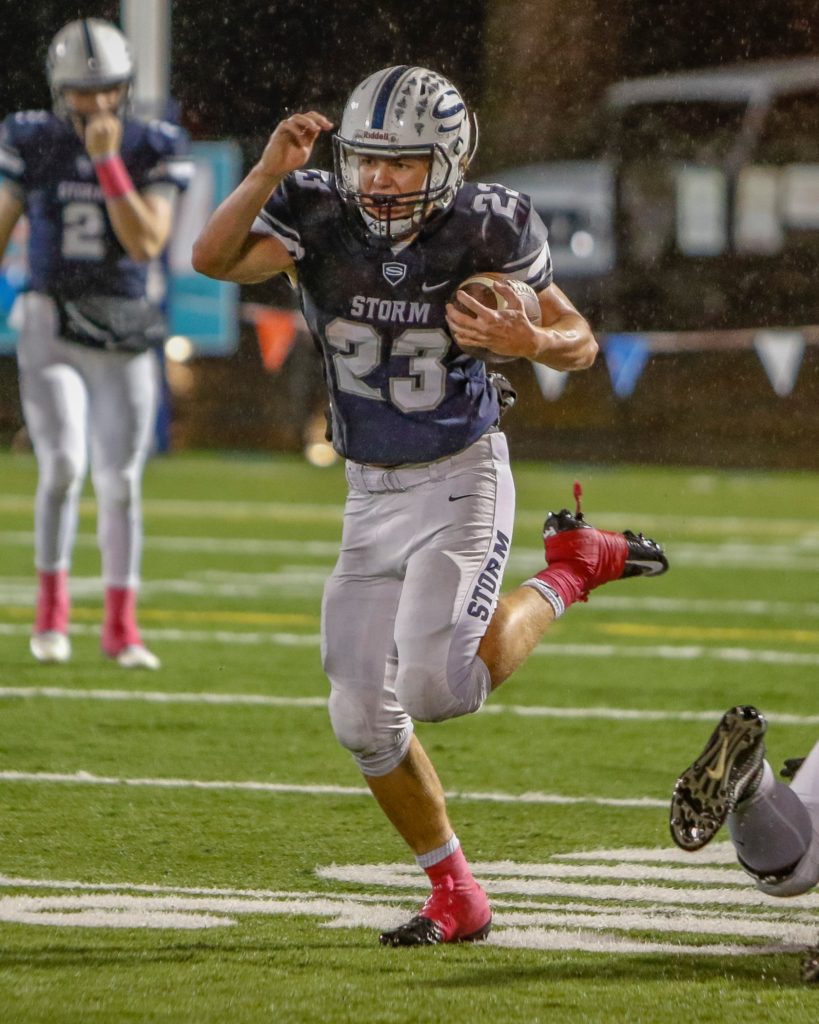 Skyview running back Hayden Froeber (23) high steps for yardage in a victory over Battle Ground. Photo by Mike Schultz.