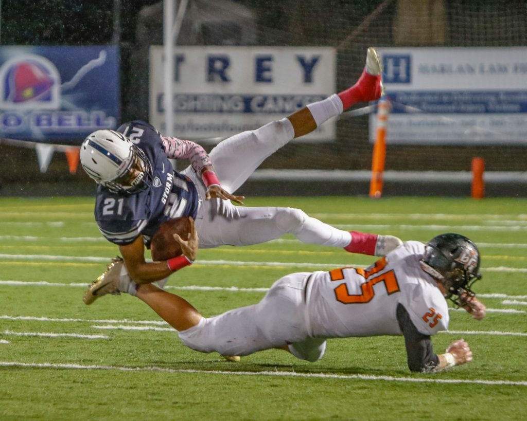 Skyview wide receiver Jeremiah Wright (21) is uphended by Battle Ground defensive back Max Randle (25). Photo by Mike Schultz.