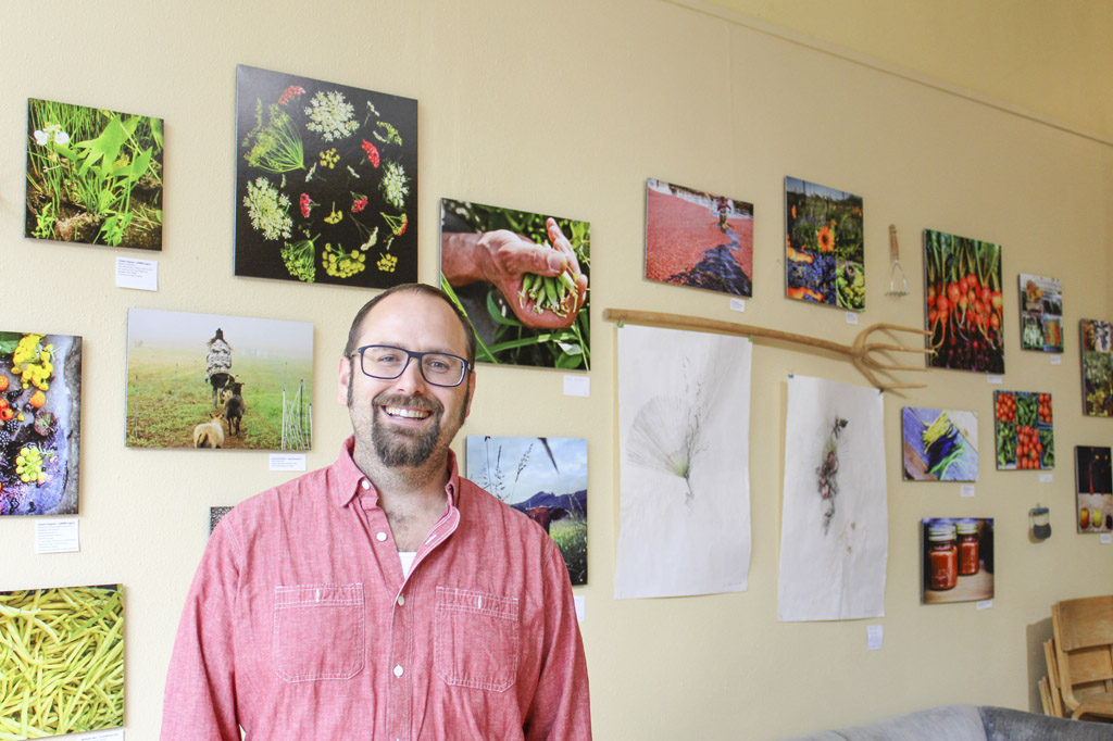 Warren Neth, executive director of Slow Food Southwest Washington, stands inside the Angst Gallery in downtown Vancouver, where his group’s art exhibit, Food Culture of Southwest Washington, runs through Oct. 29. Angst Gallery is located at 1015 Main St., Vancouver. Photo by Kelly Moyer