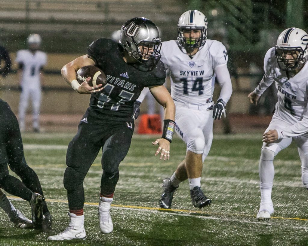 Union running back Tommy Strassenburg (47) twists for yards against the Skyview defense. Photo by Mike Schultz