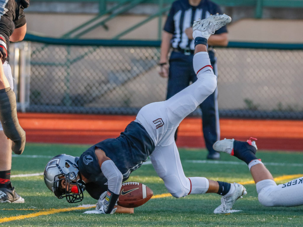 Union wide receiver Braedon Ensley (1) is uphended by a Camas defender.