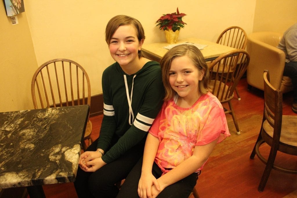 Sisters Rebekah (left) and Madi Chhav (right) are currently collecting items like stuffed animals, hats, throws and scarves to take to residents at Mallard Landing Assisted Living and Creekside Place on Christmas Day. Photo by Joanna Yorke