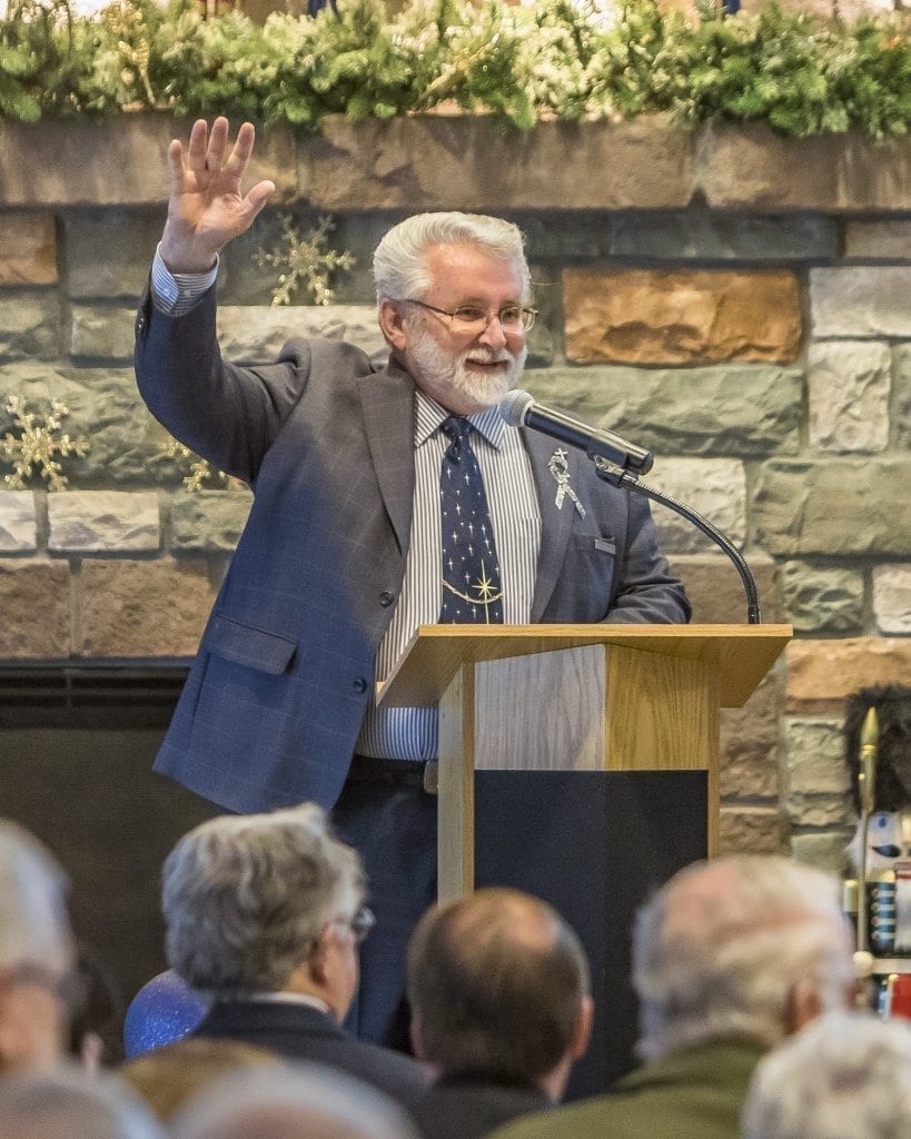 Chaplain Landis Epp, who officiated Bill Ganley’s Celebration of Life on Sunday afternoon, asks for a show of hands of people who had Ganley as a teacher, worked with him through the school district or knew him through his city government position. Photo by Mike Schultz