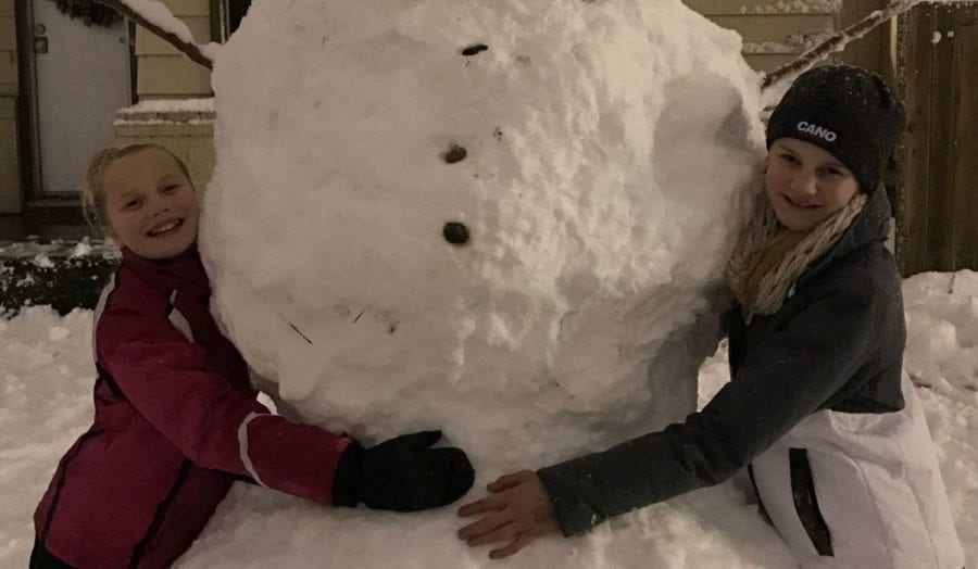 Jaicee and Brooke Mattila built a huge snowman in Vancouver at midnight Tuesday after the snow fell. Photo taken by father Joel Mattila