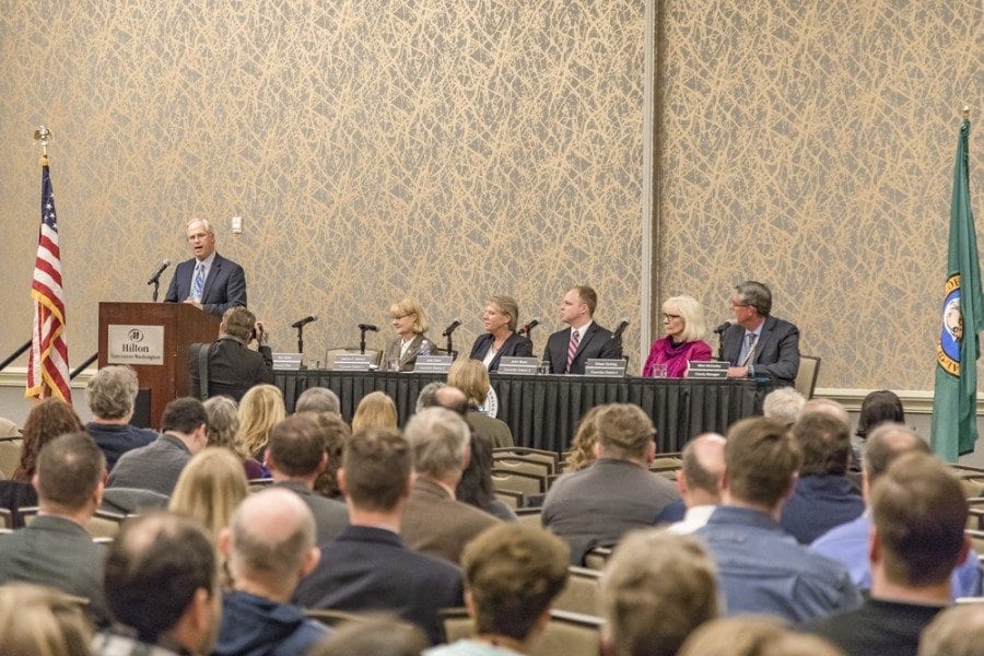 Clark County Chair Marc Boldt (at podium) addresses the crowd gathered Thursday at the Vancouver Hilton for the 2017 State of the County address. Seated (left-to-right) are Board of County Council members Jeanne Stewart, Julie Olson, John Blom and Eileen Quiring and County Manager Mark McCauley. Photo by Mike Schultz