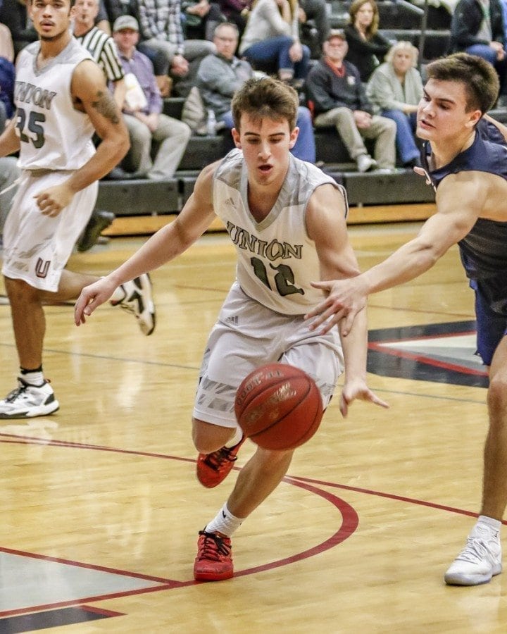 Union will meet Enumclaw Saturday at 6 p.m. at Battle Ground High School in a seeding game in the Class 4A boys state basketball tournament. Shown here is Titans’ guard Tyler Combs, an all-Greater St. Helens League first-teamer this season, in a bi-district tournament game against Olympia. Photo by Mike Schultz