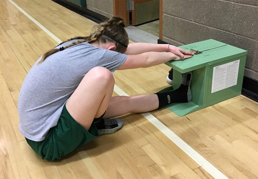 Battle Ground Public Schools’ sixth grader Kelly Monaghan performs the “back saver sit ‘n reach” test during a fitness class. Photo courtesy of Battle Ground Public Schools