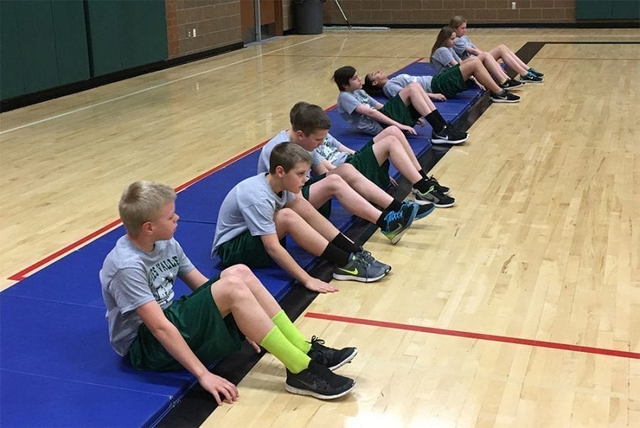 Battle Ground Public Schools’ sixth graders Jaden Tapani, Thomas Parker, Marty Bergman, Cody Thompson, Ellie Lazaroti and Katelyn Pattison perform the “curl-up” test during one of their fitness classes. Photo courtesy of Battle Ground Public Schools