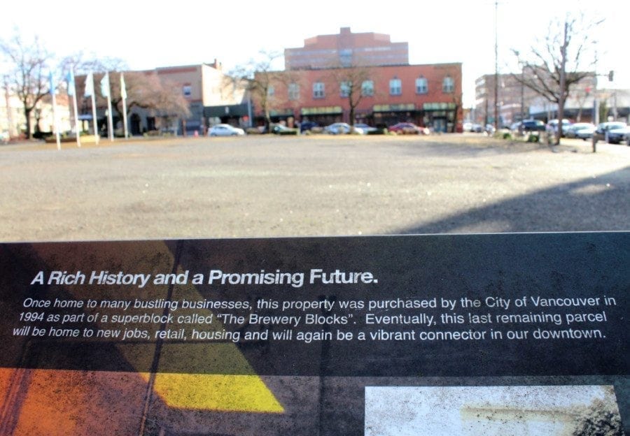 In 2012, the Vancouver Downtown Association raised funds to install the temporary Heritage Square on Block 10 and installed flagpoles, historical signs, such as the one pictured here, and flowerbeds. A developer hopes to buy the property from the city and turn it into a mix of grocery, retail and residential units. Photo by Kelly Moyer