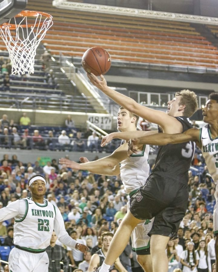 After scoring 20 points in the first half of Saturday’s championship game, Union’s Cameron Cranston was the focus of Kentwood’s defense in the final two quarters. Here, Cranston fights through two Conqueror defenders in attempt to get to the basket. Photo by Mike Schultz