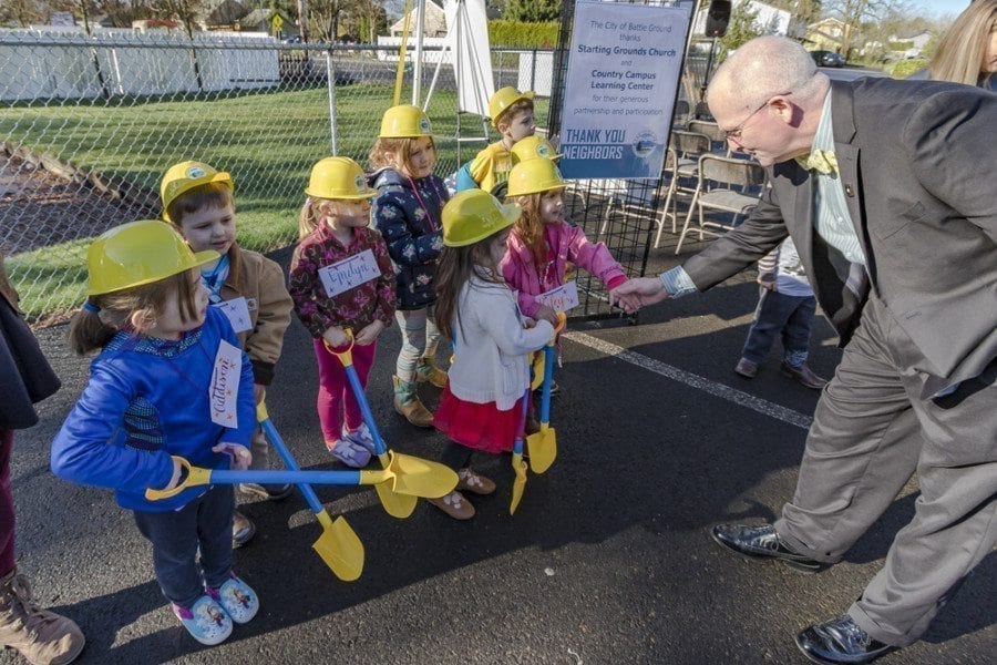 Battle Ground Mayor Philip Johnson shakes the hands of each of the children from the Battle Ground Country Campus Learning Center who attended the South Parkway Improvement Project groundbreaking ceremony on Thu., March 16. Photo by Mike Schultz