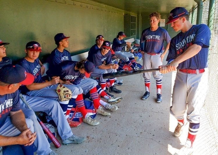 Showtime Baseball players take some rest in the shade of the dugout Thursday prior to the opening game of the Curt Daniels Invitational. The team played in a tournament in Texas and many of the players flew home around midnight Wednesday to play a day game Thursday at Propstra Stadium. Photo by Paul Valencia