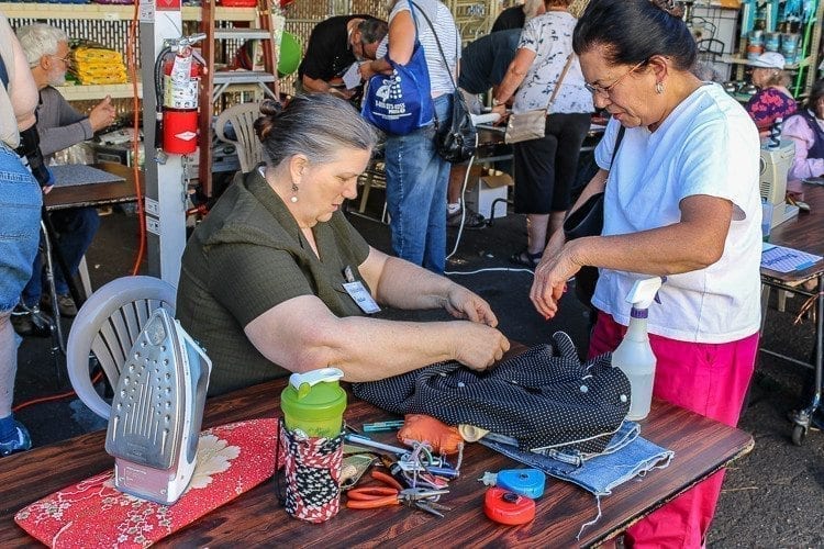 Volunteers were on hand Thursday at the Repair Café to help hand sew repairs on garments. Photo by Alex Peru