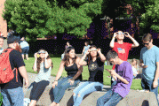 Students look skyward as county skies darken