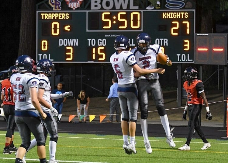 King’s Way Christian quarterback Kemper Shrock (6) and receiver Michael Garrison celebrate another touchdown Thursday night. The Knights beat Fort Vancouver 56-0. Photo by Kris Cavin