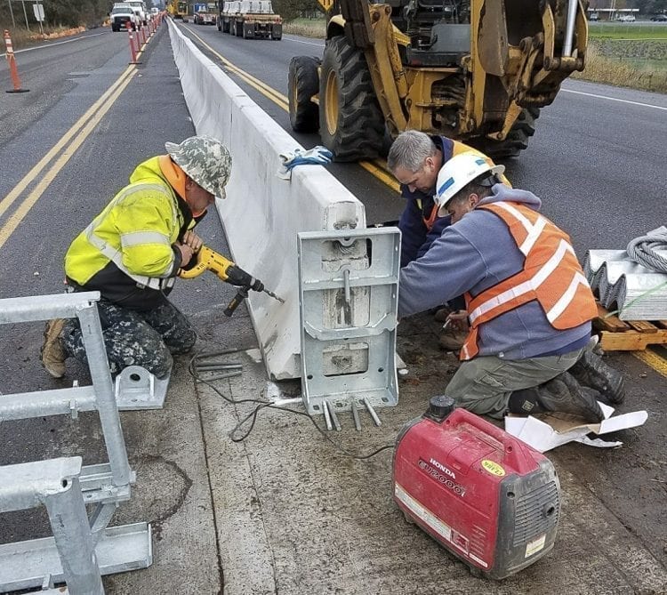 Workers from contractor Clark & Sons Excavating work to install concrete barriers on SR-503 on Fri., Dec. 1. The barriers will prevent left turns from NW 5th Way onto SR-503 or from SR-503 onto NW 5th Way behind the Fred Meyer in Battle Ground. Photo courtesy of the City of Battle Ground