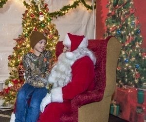 The annual Hometown Holidays event in downtown Camas had attractions for all ages. Children were drawn to the opportunity to have their photo taken with Santa Claus. Brayden Butterfield of Camas tells Santa, played by Camas resident Rick Knapp, what he wants for Christmas. Photo by Mike Schultz