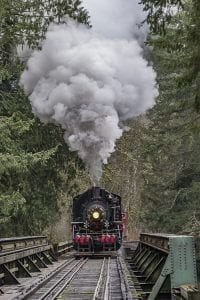 The Chelatchie Prairie Railroad’s restored steam engine crosses the railroad bridge over the East Fork of the Lewis River during a Christmas tourist excursion on Saturday. Photo by Mike Schultz