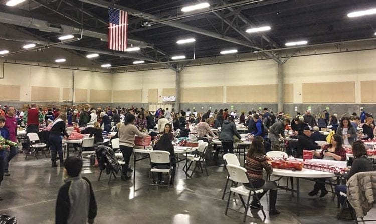 During the all volunteer wrapping party hosted by Santa’s Posse to prepare Christmas gifts, 500 volunteers at a time have sometimes come to help support local families. Photo courtesy of Santa’s Posse