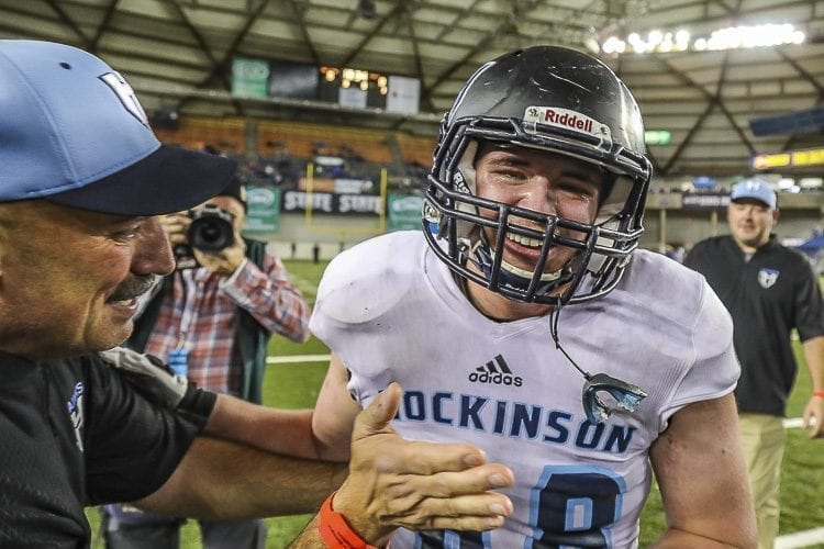 Hockinson coach Rick Steele (left) gives senior Ryan Sleasman (68) a well-deserved pat after the Hawks claimed the Class 2A state high school football championship with a win over Tumwater Saturday at the Tacoma Dome. Photo by Mike Schultz