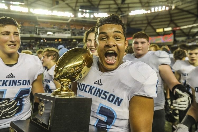 Hockinson senior Kordell Johnson gets his moment to hold the Class 2A state championship trophy after the Hawks’ 35-22 victory over Tumwater Saturday at the Tacoma Dome. Photo by Mike Schultz
