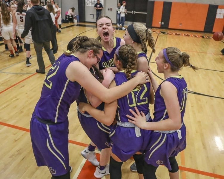 The Columbia River Chieftains celebrate their big win over Washougal to open the Class 2A District 4 girls basketball tournament. Washougal came into the tourney as a top seed after winning the 2A Greater St. Helens League. Columbia River was fifth in that league. Photo by Mike Shultz