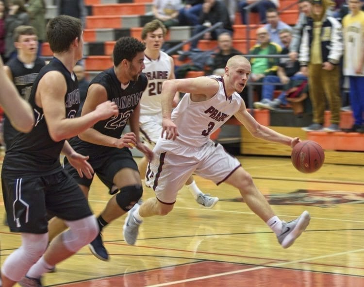 Prairie’s Kameron Osborn (3) drives past Arlington defenders Saturday in a Class 3A state regional basketball game at Battle Ground High School. Osborn scored 29 points, leading Prairie to the Tacoma Dome next week. Photo courtesy of Glen Erickson