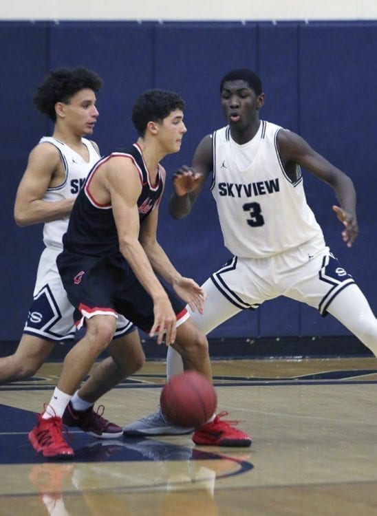 Skyview senior Samaad Hector (3) is a rebounding and blocked shot specialist but also has no trouble helping a teammate on defense. Photo courtesy of Sports Mom Photos