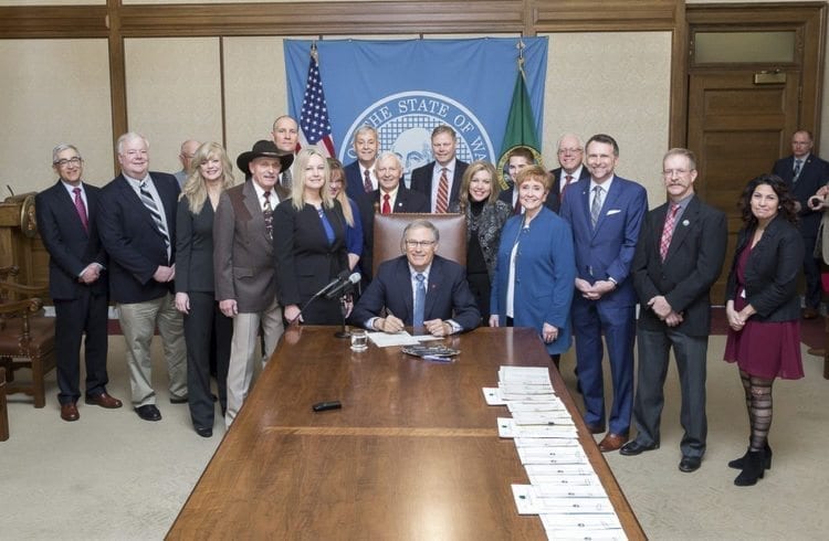 WA Governor Jay Inslee poses with SW Washington lawmakers and members of the Port of Ridgefield after signing House Bill 2664. Photo courtesy Port of Ridgefield