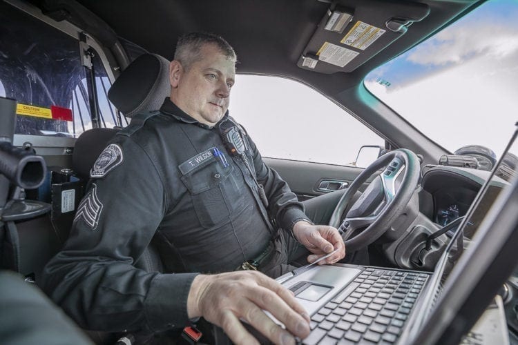 Battle Ground Police Sergeant Tim Wilson checks a driver’s information during a distracted driving sting on April 10. Photo by Mike Schultz