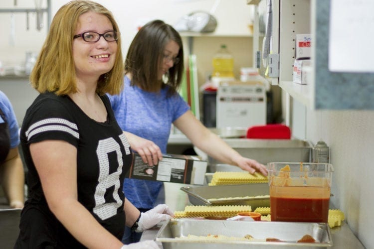 Ruth Richards (left), an eighth grader at Woodland Middle School, volunteered to cook her chicken lasagna recipe for the entire school, selling out the day it was served. Photo courtesy of Woodland Public Schools
