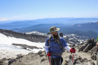A climber pauses to chat with others on the trail to the summit A climber pauses to chat with others on the trail to the summit. Photo by Eric Schwartz