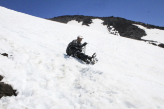 A man glissades down the slopes of Mount St. Helens (1) A man glissades down the slopes of Mount St. Helens. Photo by Eric Schwartz
