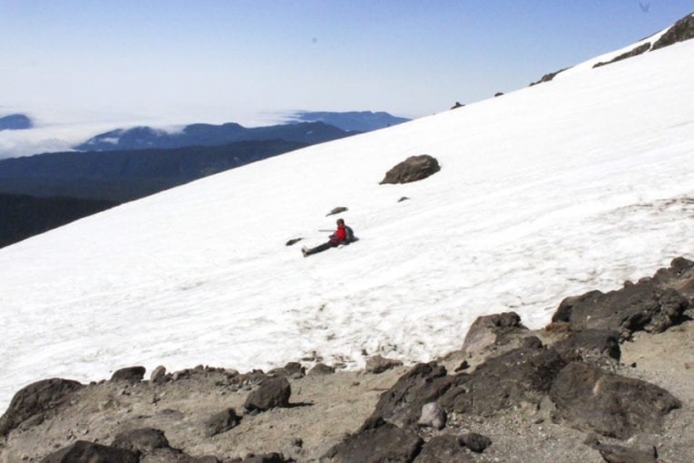A man glissades down the slopes of Mount St. Helens. Photo by Eric Schwartz