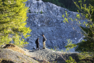 A pair of hikers take in the scenery near the start of the path to the summit A pair of hikers take in the scenery near the start of the path to the summit. Photo by Eric Schwartz