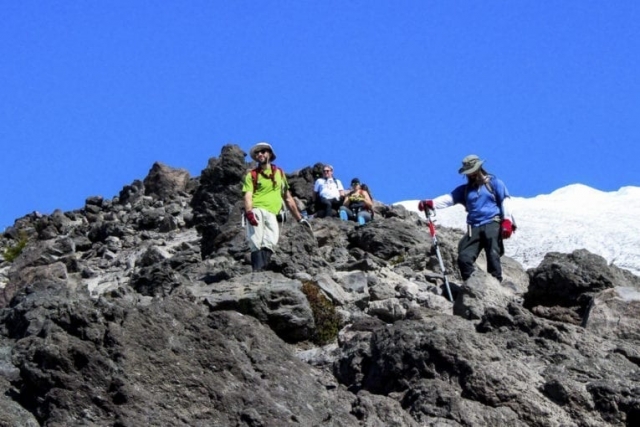 Climbers pause for a break on a rocky outcropping Tuesday on the route to Mount St. Helens. Photo by Eric Schwartz