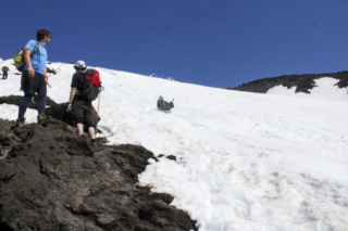 Hikers and those glissading down the slopes of Mount St. Helens cross paths (1) Hikers and those glissading down the slopes of Mount St. Helens cross paths. Photo by Eric Schwartz