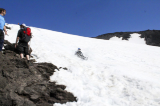 Hikers and those glissading down the slopes of Mount St. Helens cross paths (2) Hikers and those glissading down the slopes of Mount St. Helens cross paths. Photo by Eric Schwartz