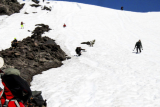Hikers and those glissading down the slopes of Mount St. Helens cross paths Hikers and those glissading down the slopes of Mount St. Helens cross paths. Photo by Eric Schwartz
