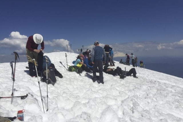 Hikers rest at the summit of Mount St. Helens Tuesday. Photo by Eric Schwartz